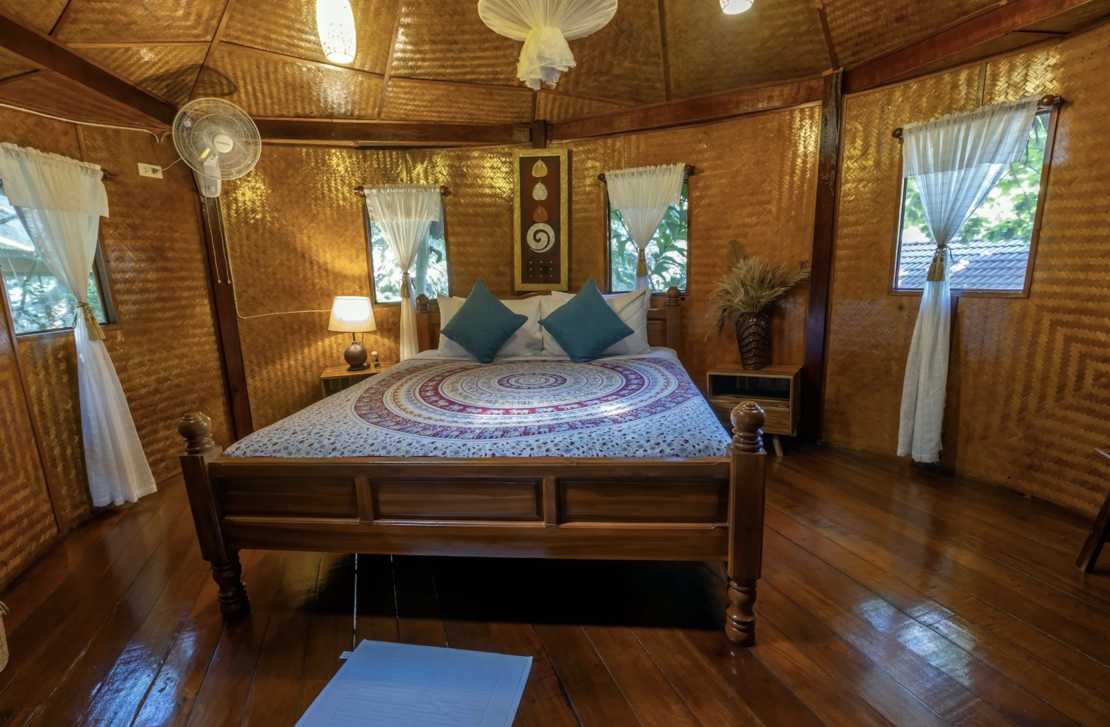 Warm wooden bedroom interior with a large bed and woven walls